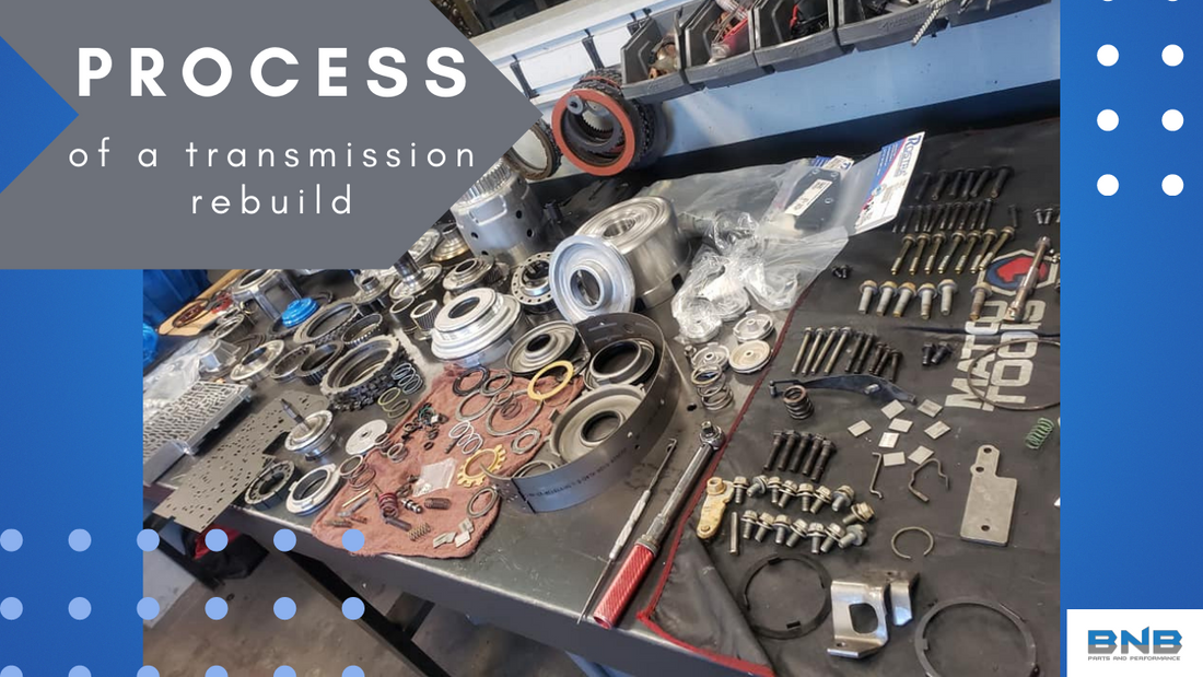 transmission parts organized on table inside automotive shop